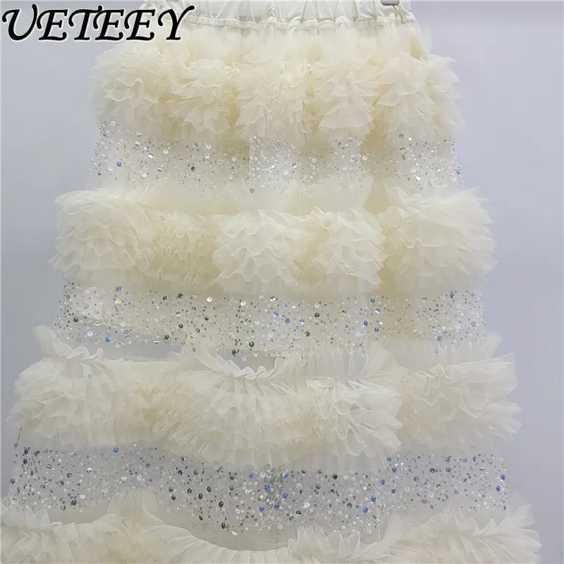 กระโปรงยาวทรงเค้กแต่งระบายผ้าทูลล์ประดับเลื่อมเอวสูงยางยืด สไตล์แฟชั่นใหม่รับฤดูใบไม้ผลิปี 2026 สีแอปริคอต ดีไซน์อเนกประสงค์สำหรับผู้หญิง