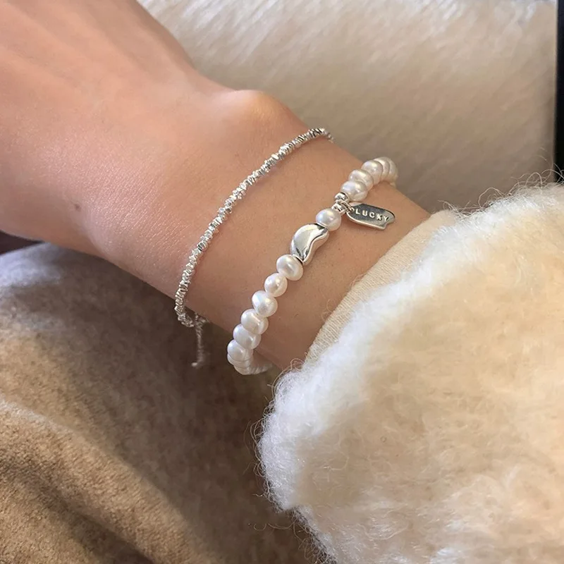 

Light luxury niche design natural pearl bracelet women's 925 sterling silver lucky bean Lucky tag fold wear hand jewelry