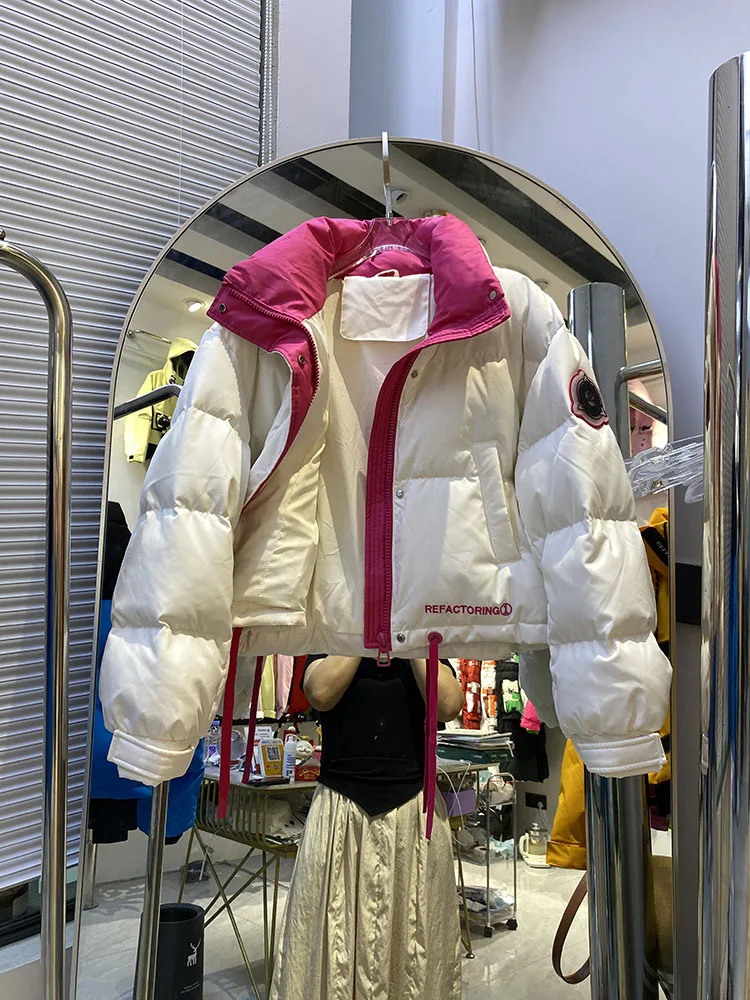 Chaqueta de plumón cálida con capucha para mujer, chaqueta de plumón de pato blanco a la moda con temperamento elegante, novedad de invierno de 2025