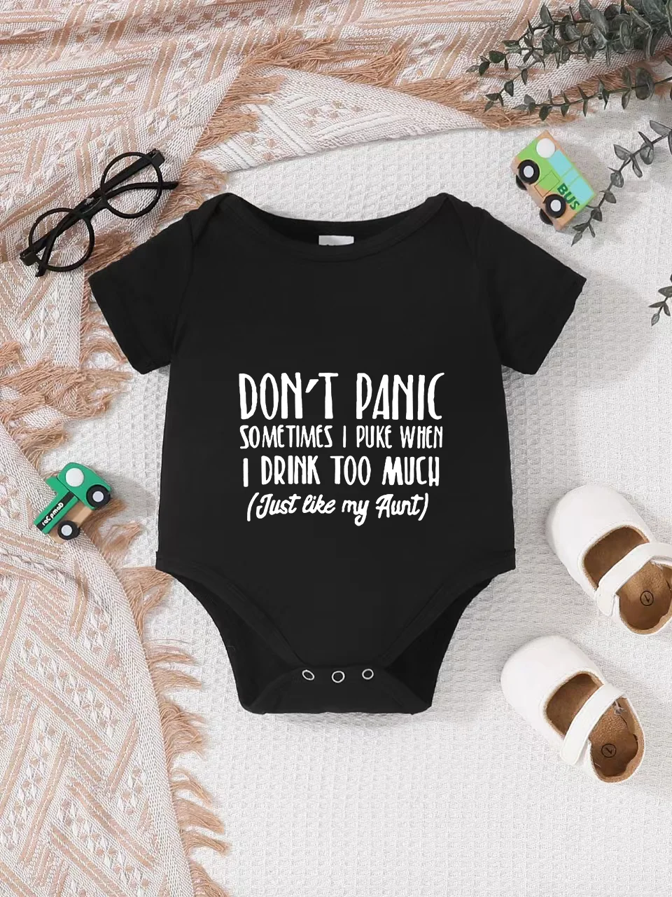 Playful letter-printed baby short-sleeve triangle bodysuit. Button closure for easy dressing, machine washable