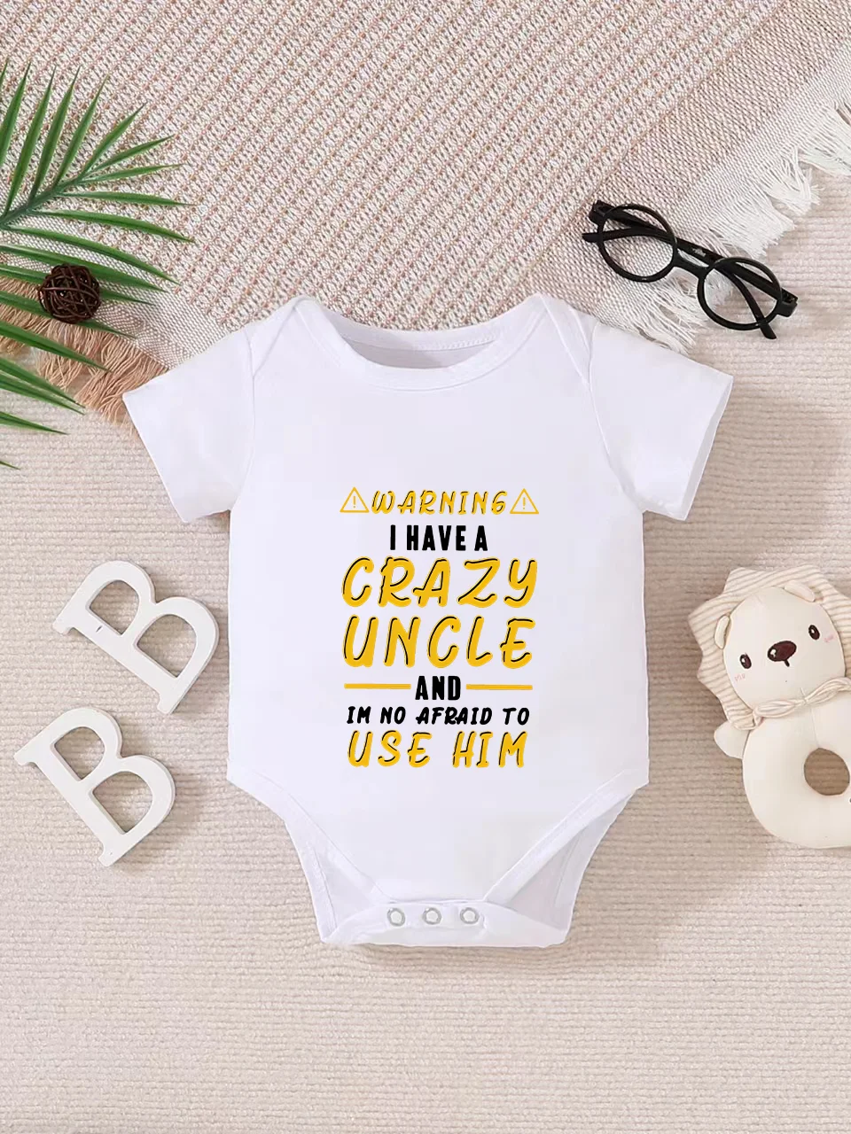 Playful letter-printed baby short-sleeve triangle bodysuit. Button closure for easy dressing, machine washable