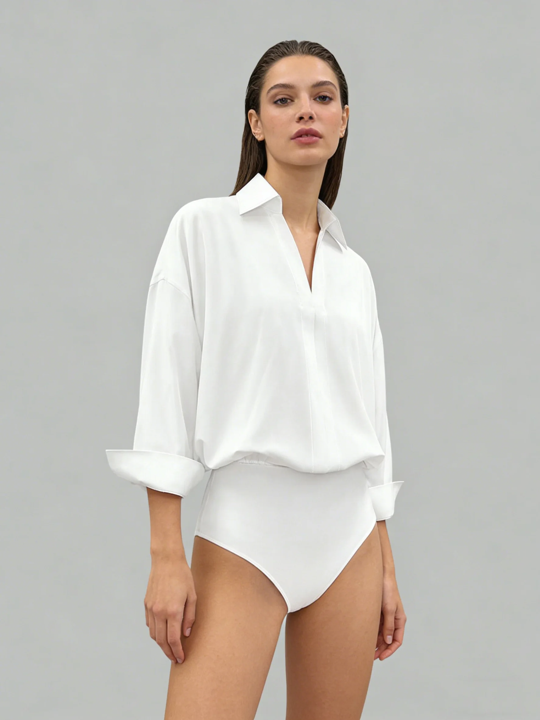 Oversized solid-colored jumpsuit with long sleeves in a versatile shirt style