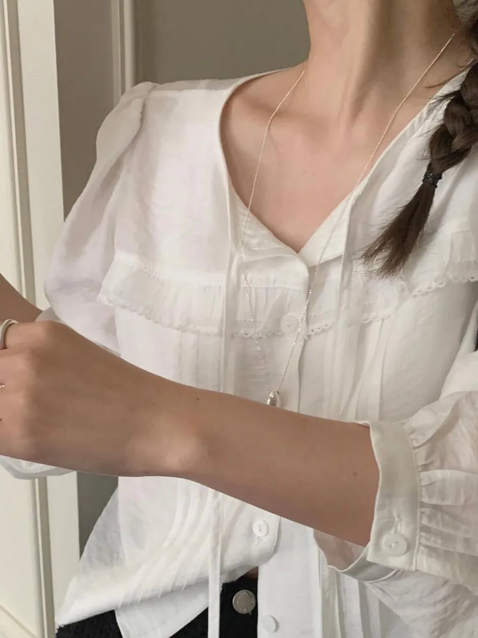 

Korean Sle Sweet Ruffle Hem Long Sve ort irt Women Early Autumn New Single Button Bubble Sve ort Top