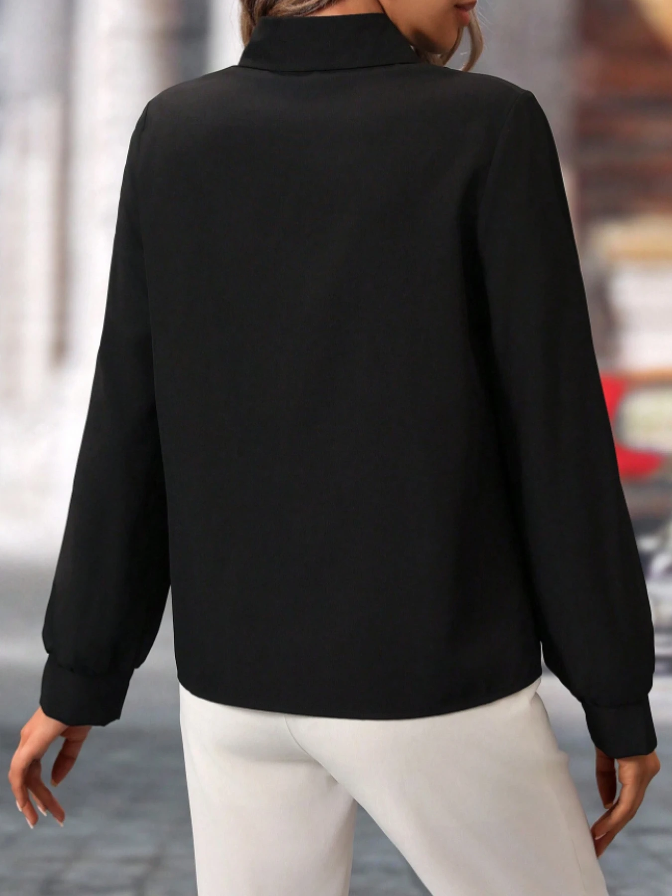 قميص نسائي ذو طية صدر السترة باللون الأسود مع أزرار لؤلؤية وأكمام طويلة بتصميم رفيع