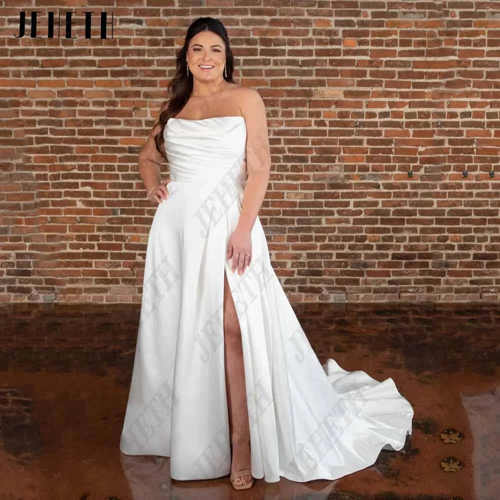 

JEHETH Elegant Plus Size Wedding Dress for Bride Sleeveless Strapless Satin Bridal Gown A - Line Side SplЖенское свадебное платье без рукавов JEHETH, элегантное атласное платье-трапеция с разрезом по бокам, модель 2023