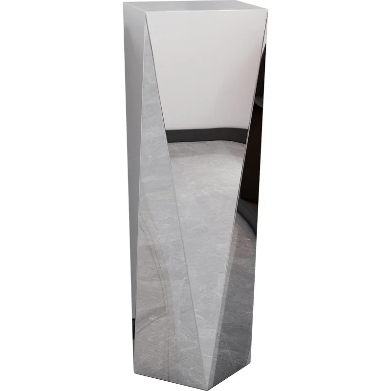 

Stainless steel sculpture table next to TV cabinet flower stand Italian light luxury living room floor ornament table