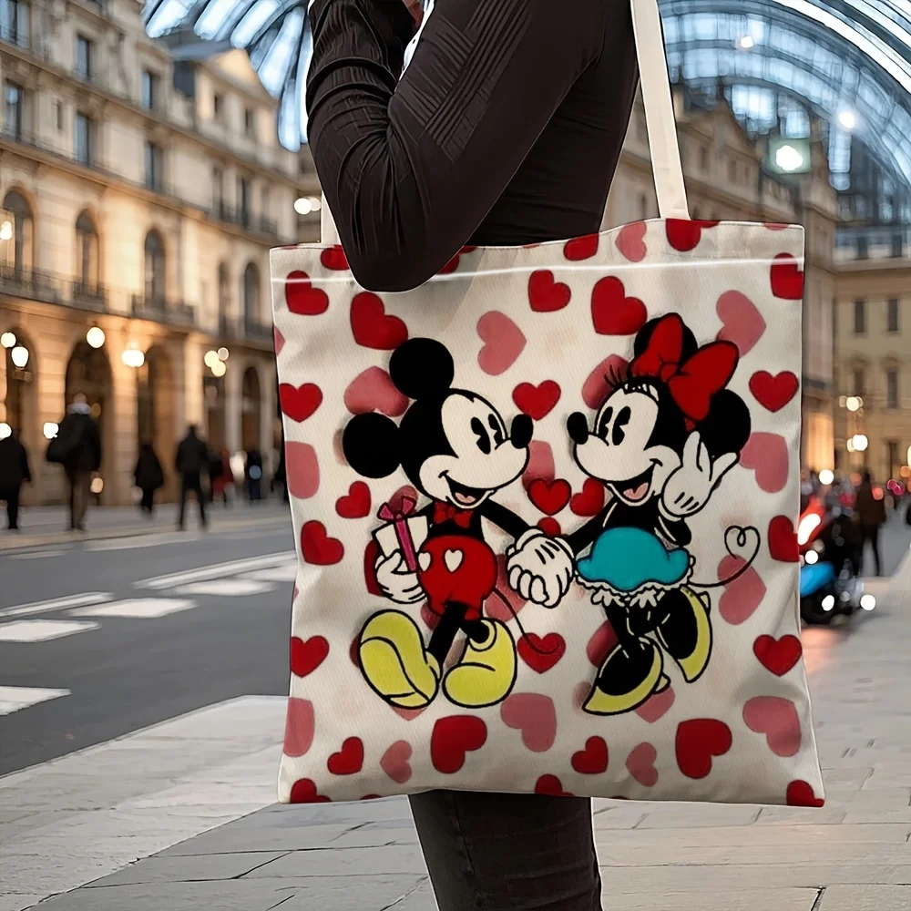1 bolsa de compras de lona reutilizable con diseño de Mickey y Minnie de manos entrelazadas, con corazón rojo y rosa, adecuada para uso diario, compras, escuela y viajes.