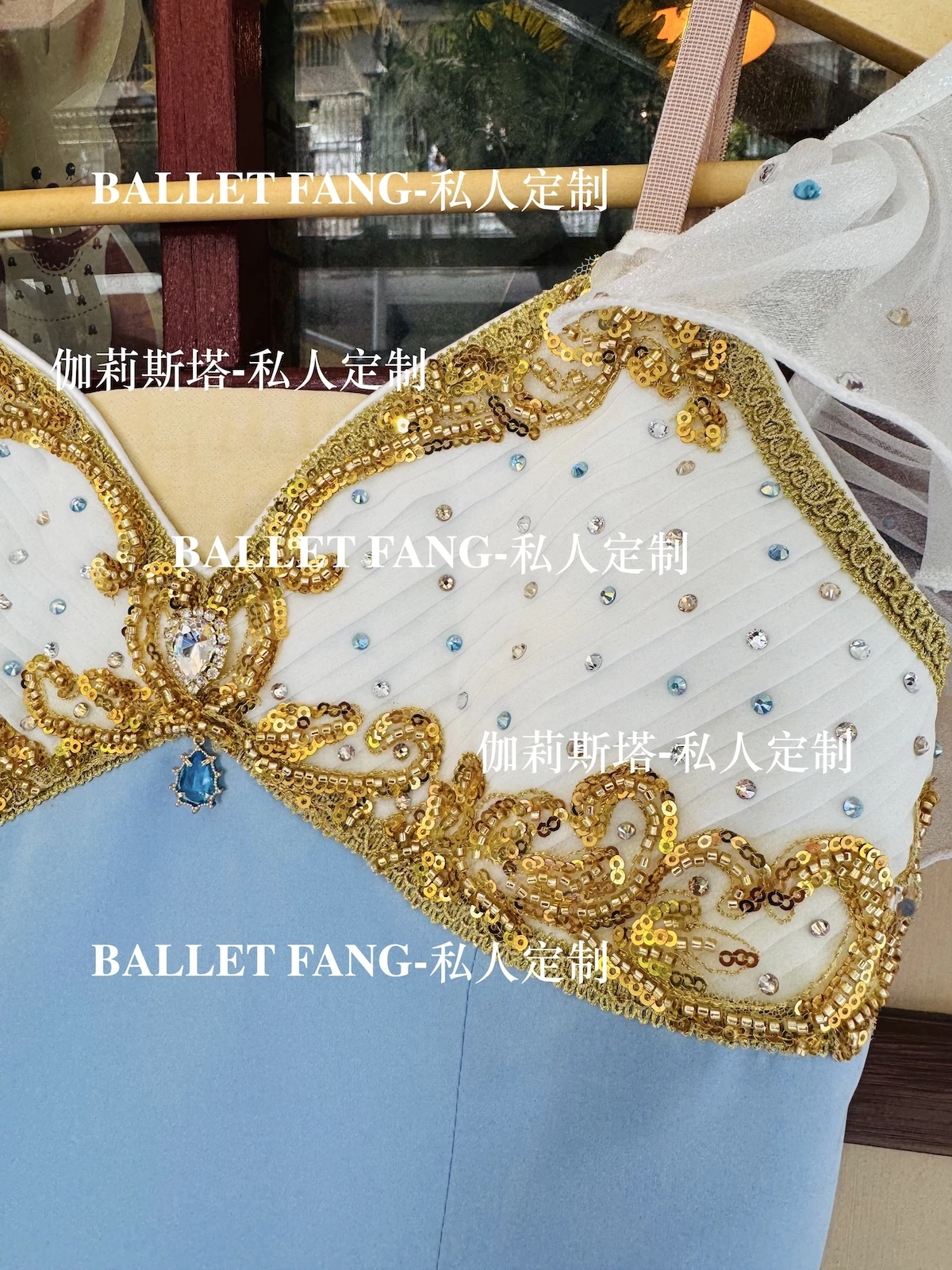 A custom-made ballet dress for the Swan Lake scene, with a blue gradient color, gold sparkling diamonds and a white long chiffon