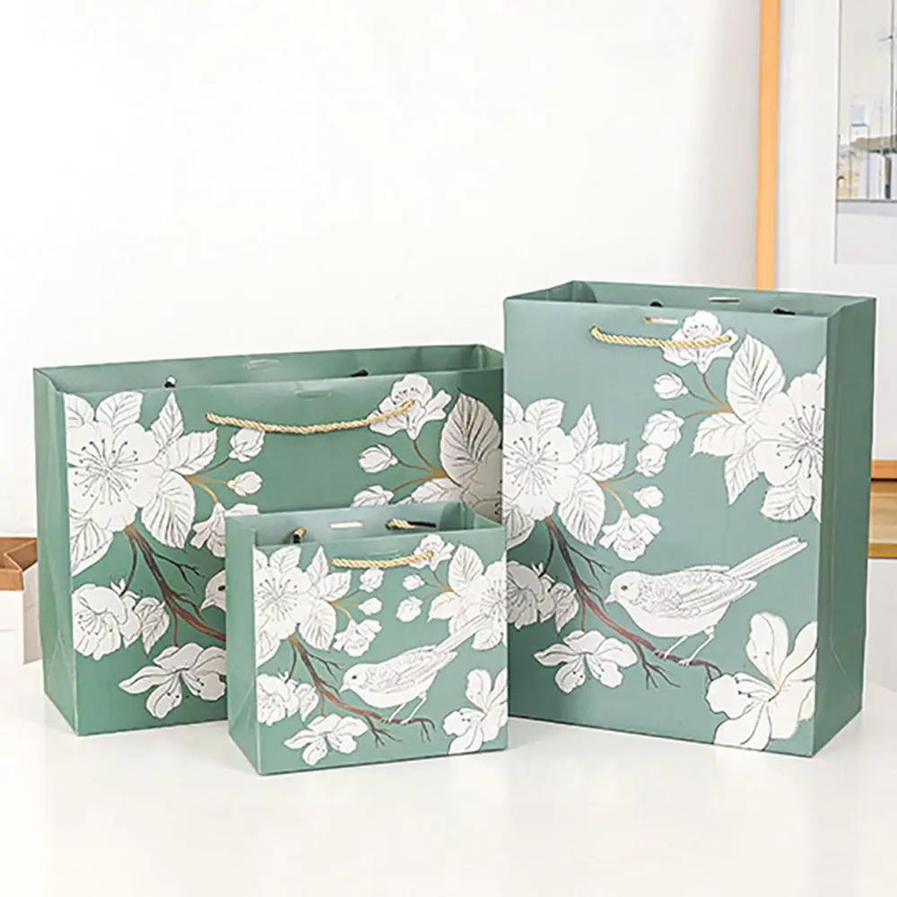 Verdickte luxuriöse grüne Handtasche aus Papier, bedruckt mit Blumenvogel und Bandverpackung, Einkaufstasche