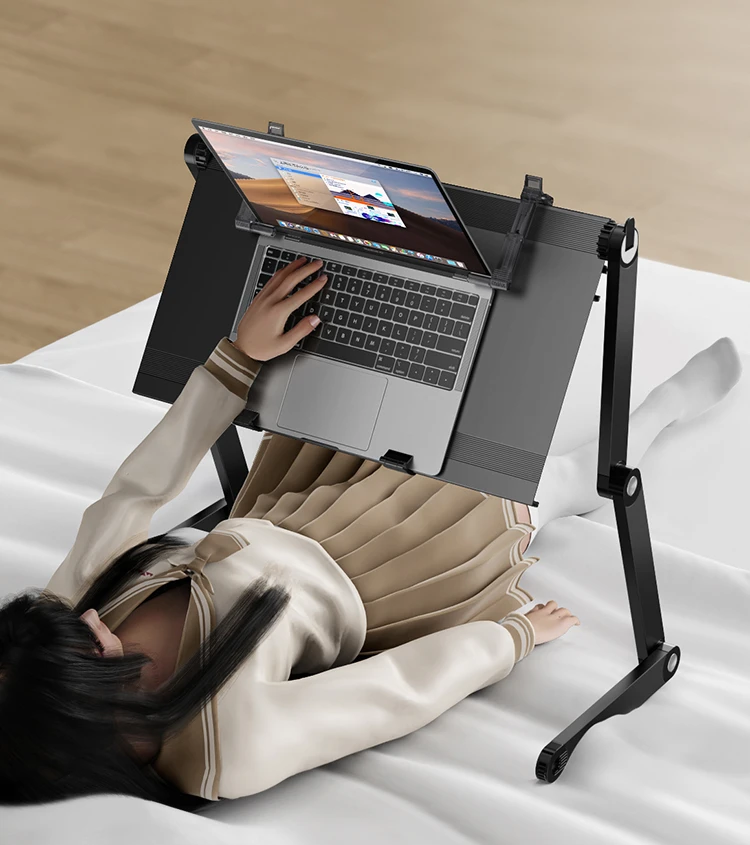 Lying flat on a small table in bed with a computer, laptop, folding table lying down, lazy table lifting and lowering