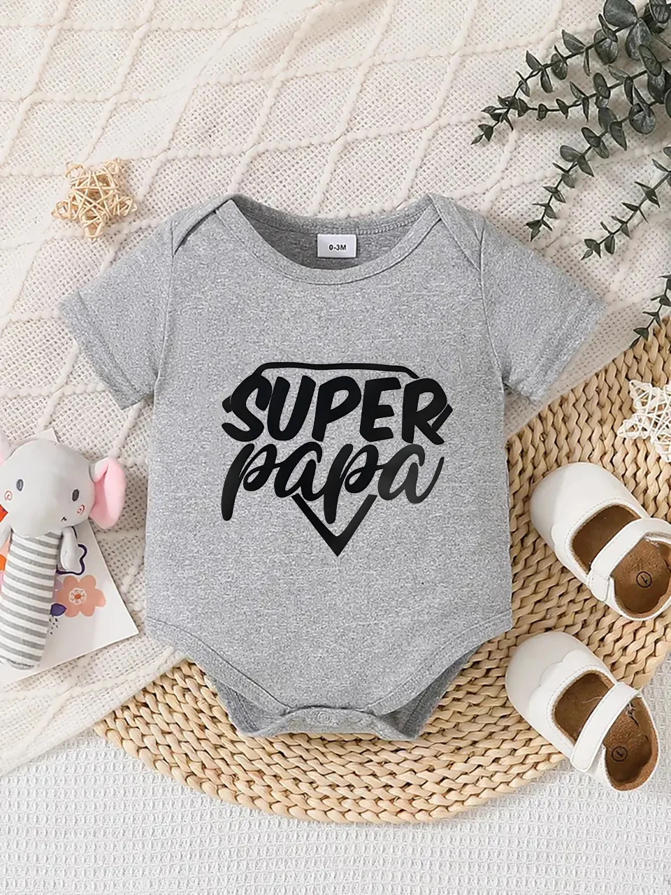 Playful letter-printed baby short-sleeve triangle bodysuit. Button closure for easy dressing, machine washable