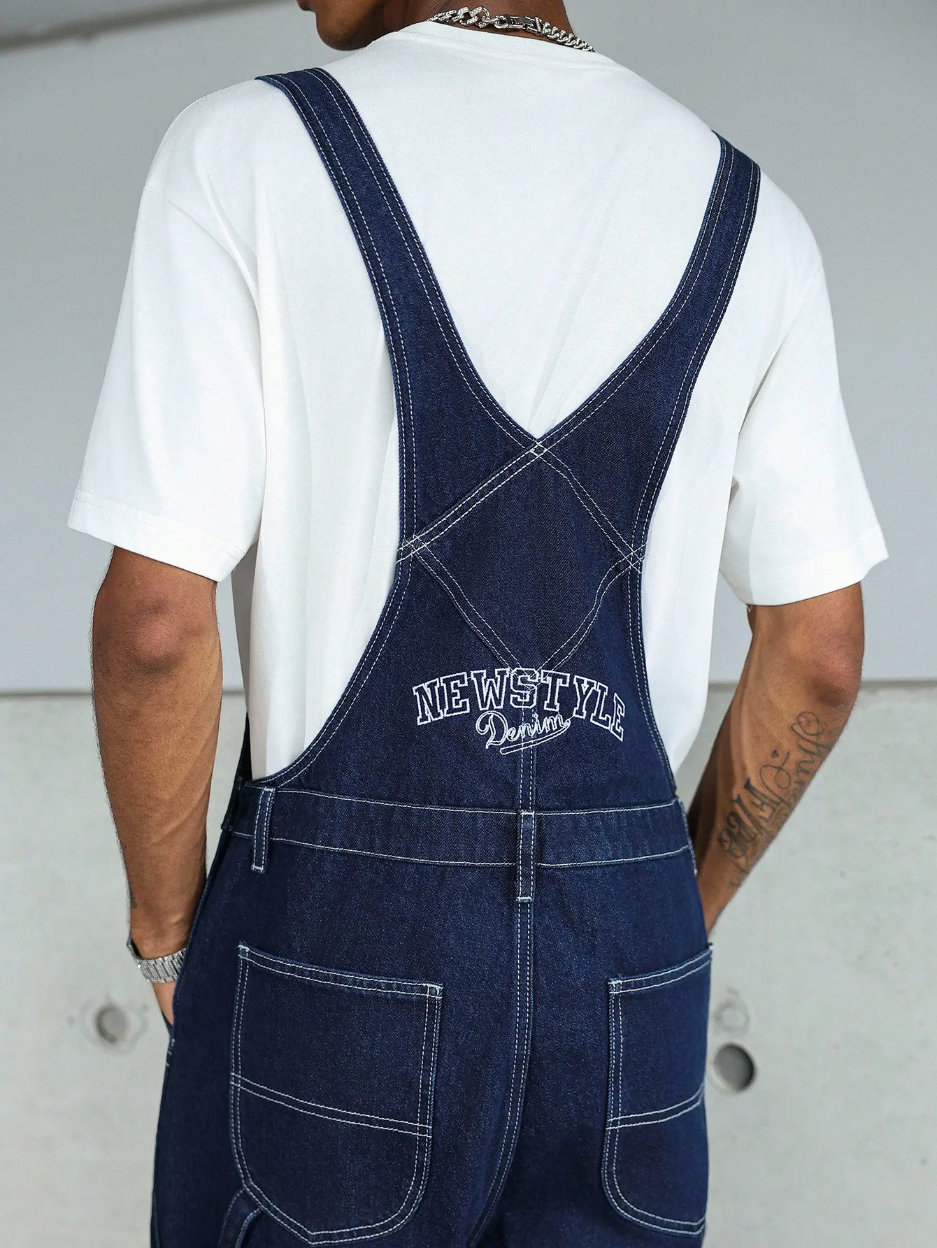 High-quality blue washed multi-pocket denim cargo pants with adjustable shoulder straps, perfect for casual wear in all seasons.