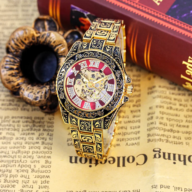 

A men's black and gold steel strap business-style watch with an engraved hollow automatic mechanical case