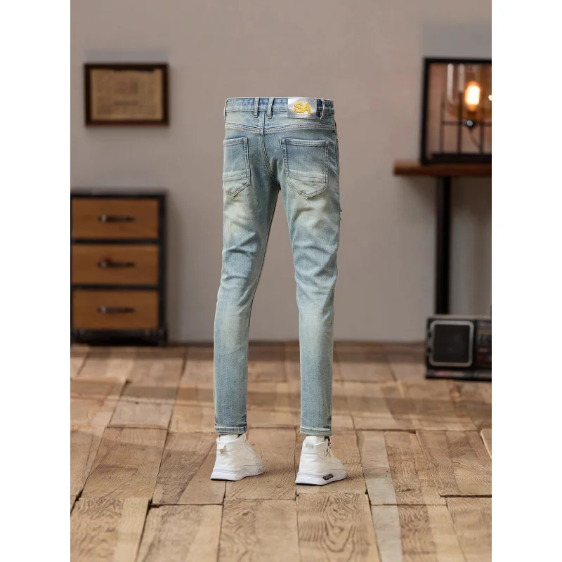 جينز ممزق وسيم للشارع روفيان لعام 2025 للرجال ذو اتجاه حنين عتيق بقصة ضيقة وأقدام صغيرة سراويل مخصصة متعثرة