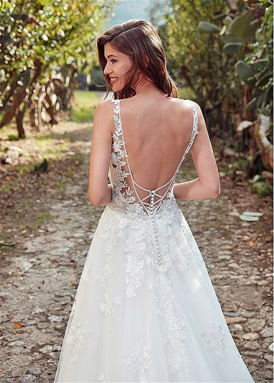 Vestido de novia de línea a con escote de Joya de tul, con apliques de encaje y abalorios, espalda abierta