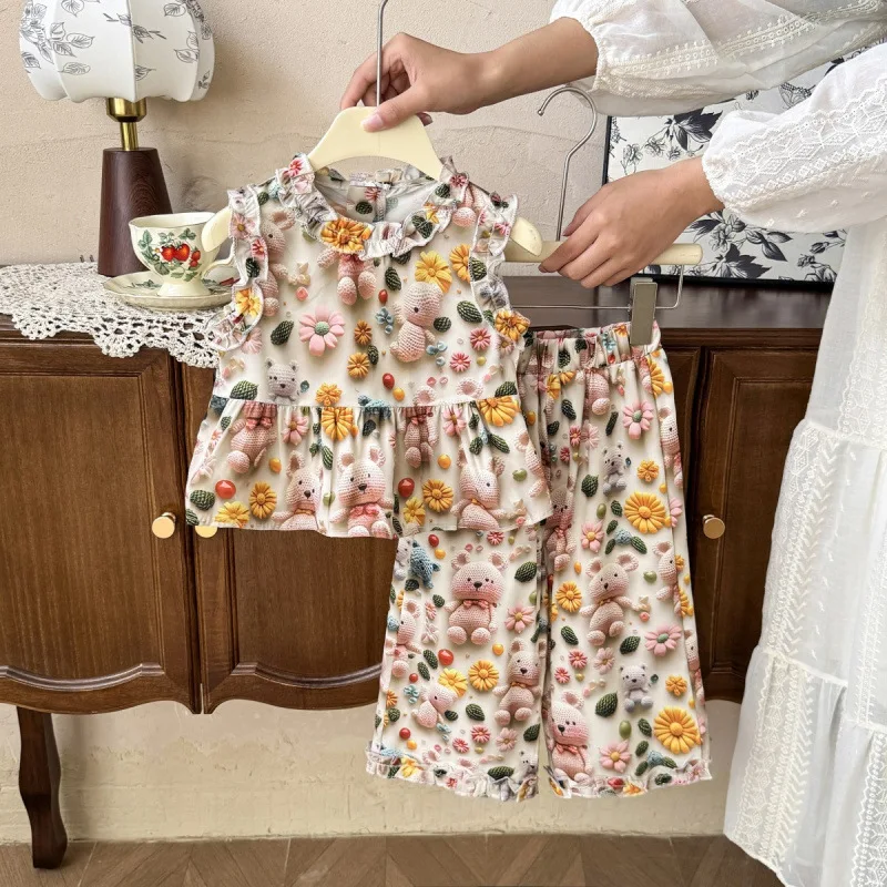 

Children's Summer Outfit for Girls: Stylish Cartoon Print Tank Top, Casual Floral Shorts, Wide-Leg Pants Three-Piece Set