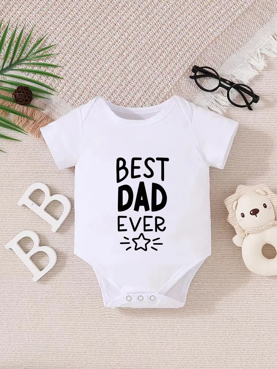 Playful letter-printed baby short-sleeve triangle bodysuit. Button closure for easy dressing, machine washable