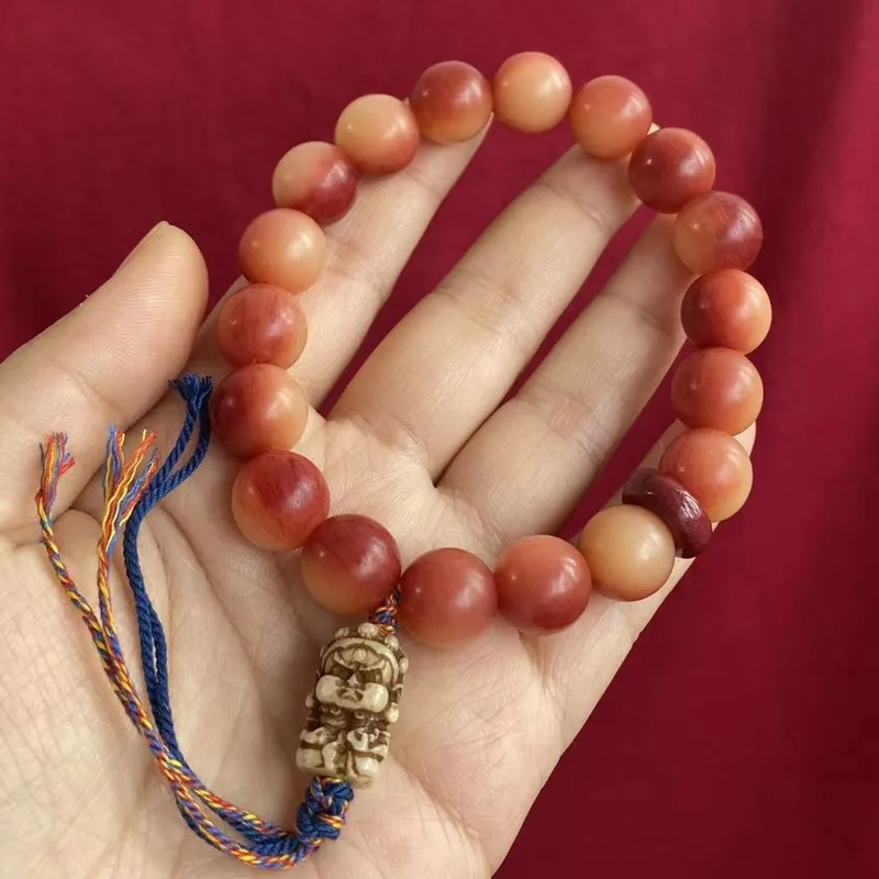 Camel bone bloodstone bracelet with 12mm round beads, paired with a coin-shaped Buddha head and a small lion, featuring a unique