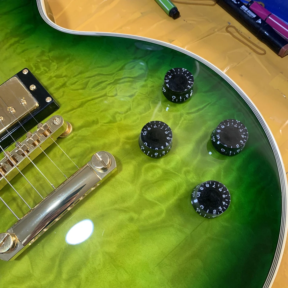 Electric guitar with green maple top, gold hardware, rosewood fingerboard