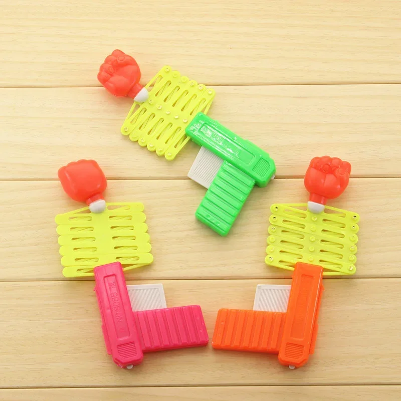 Speelgoed Vuistgeweer Kinderplezier Nieuwigheid Klaslokaal Onderwijs Grappig Vingerlezen Rekwisieten Nostalgische jeugdherinneringen Klassiek speelgoed