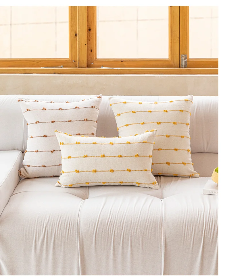 Pink and yellow striped pillow covers in square and lumbar shapes