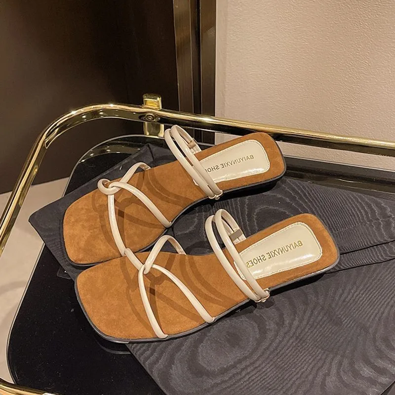 

The 2025 new stylish and lightweight one-strap slippers with thick heels and crossed thin straps for summer wear outside