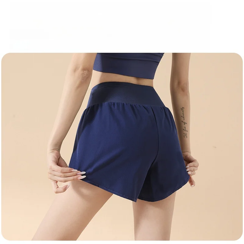 شورت رياضي نسائي عالي الخصر مكون من قطعتين مع جيوب جانبية مضاد للانزلاق فضفاض مناسب لرفع الورك والجري واليوجا شورت رفيع