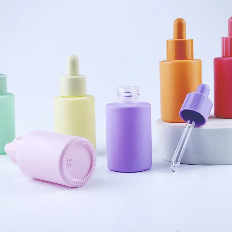 

In stock wholesale Luxury flat shoulder colorful frosted essential oil serum glass dropper bottle for cosmetic with dropper lids