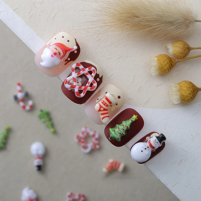 10pcs คริสต์มาสเรซิ่นเล็บอุปกรณ์เสริม 3D การ์ตูน Santa Claus Cane ถุงเท้า Snowman Nail Art Design อุปกรณ์ตกแต่ง