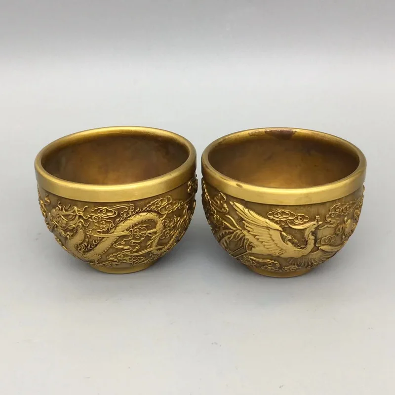 Antique-style copperware collection: a pair of brass dragon and phoenix small wine glasses, vintage home wine cabinet decorative