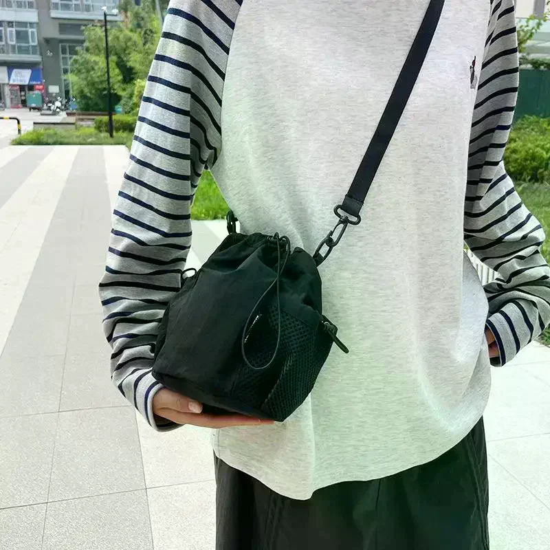 Light Purple Nylon Drawstring Crossbody Bag With Adjustable Strap Mesh Pocket For Daily Use Shopping Trips