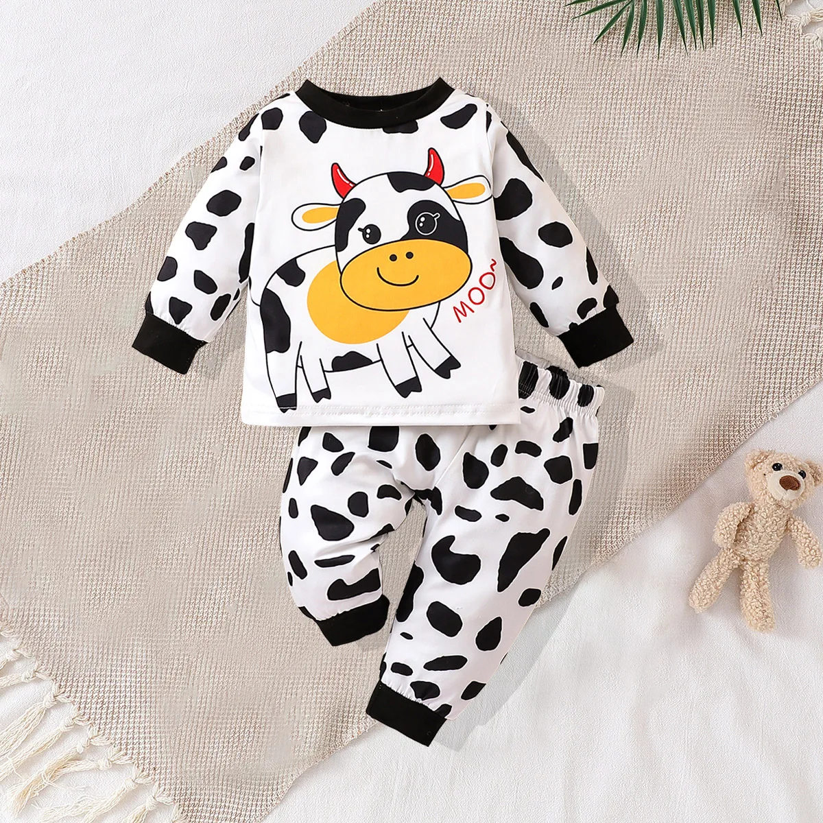 

Two piece cute and fashionable black and white spotted cow print long sleeved round neck top and pants set for baby boys