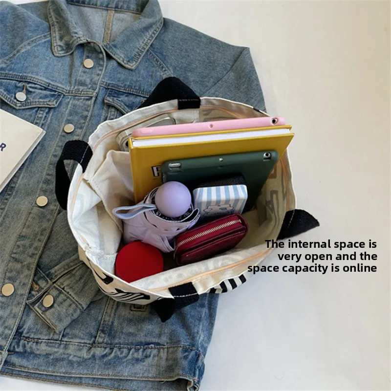 ファッションプリントストライプキャンバスバッグ、大容量裏地ハンドバッグ、キャンパス学生バックパック、若者の日常ショッピング文学用途