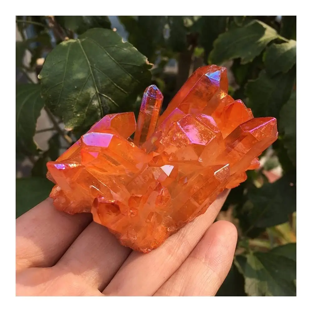 A cluster of orange quartz crystals with a rainbow halo, perfect for crystal collectors.