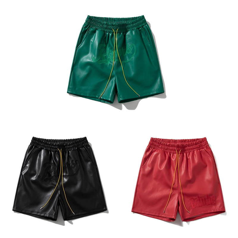 Haftowane logo Jednokolorowe skórzane spodenki sportowe w stylu retro Europejskie amerykańskie modne luźne spodenki ze sznurkiem High Street