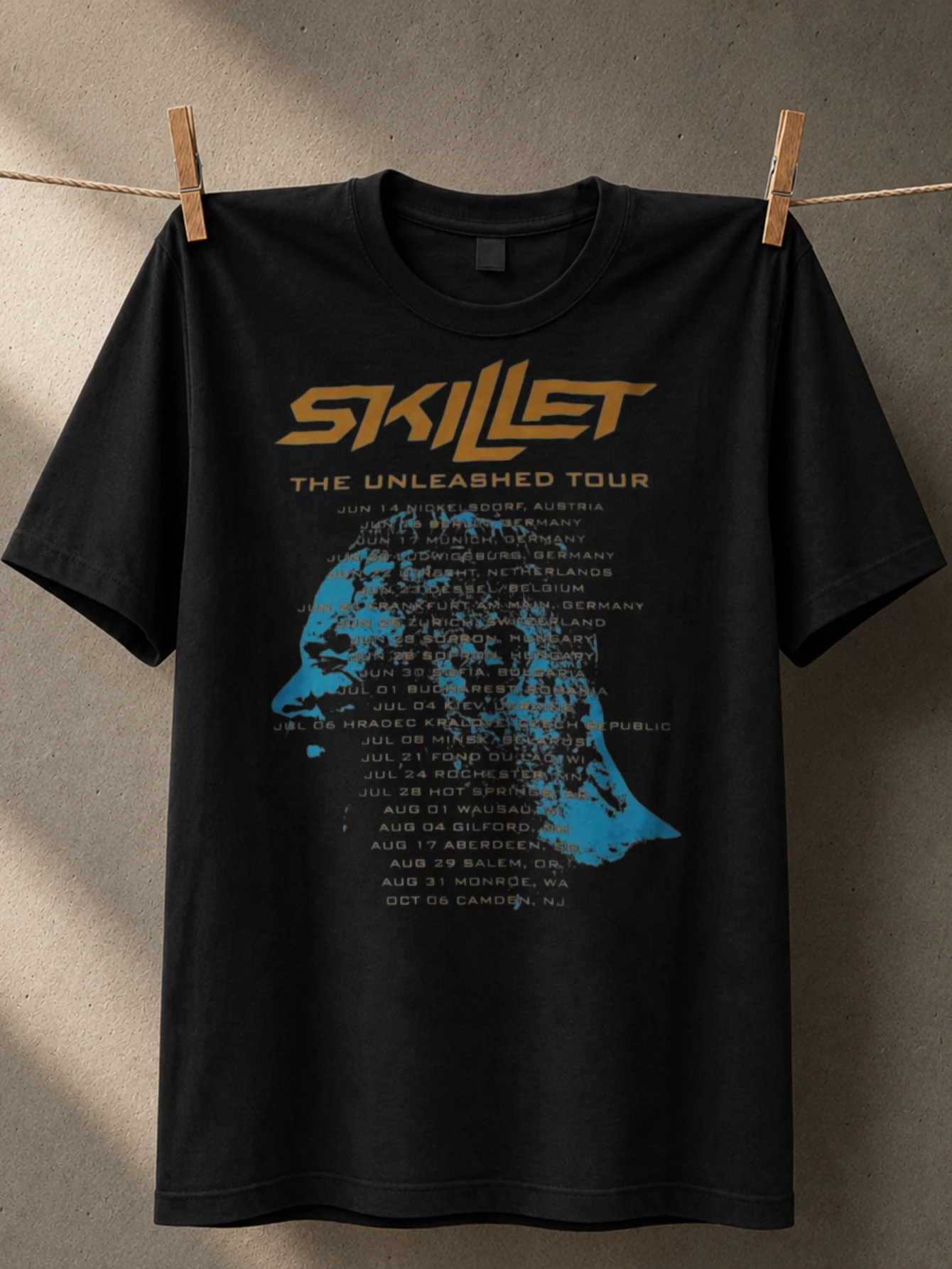Skillet Unleashed Tour gold logo over blue silhouette concert date list and dark gritty stage  Unisex All T-Shirt