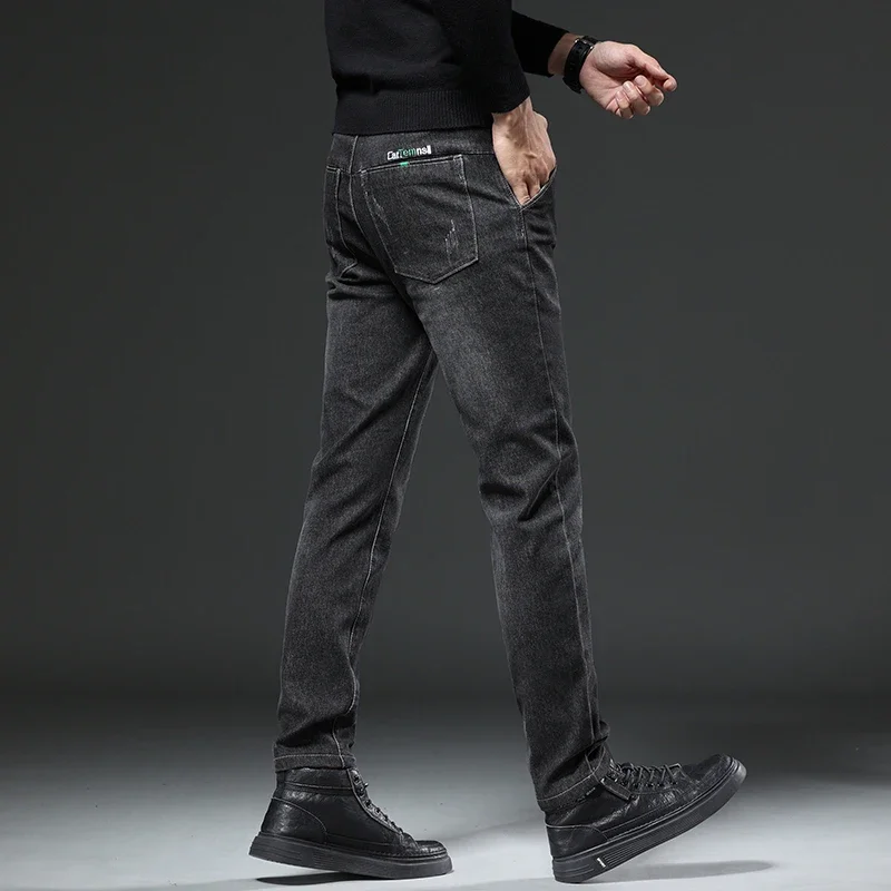 秋と冬の新作伸縮性のあるルーズフィットペンシルパンツファッションブランドデニムメンズジーンズカジュアルハーランパンツ