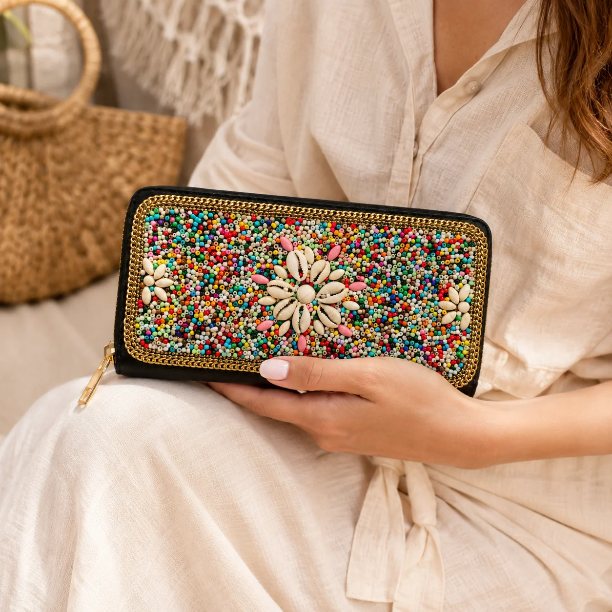 Colorful boho zip-around wallet featuring hand-applied seed bead decoration and shell-inspired floral details. Made with a black