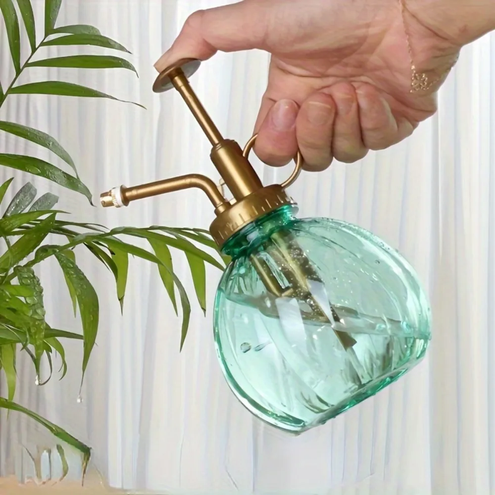 An antique plastic pumpkin shaped garden watering pot, a general holiday plant care spray, with an adjustable nozzle