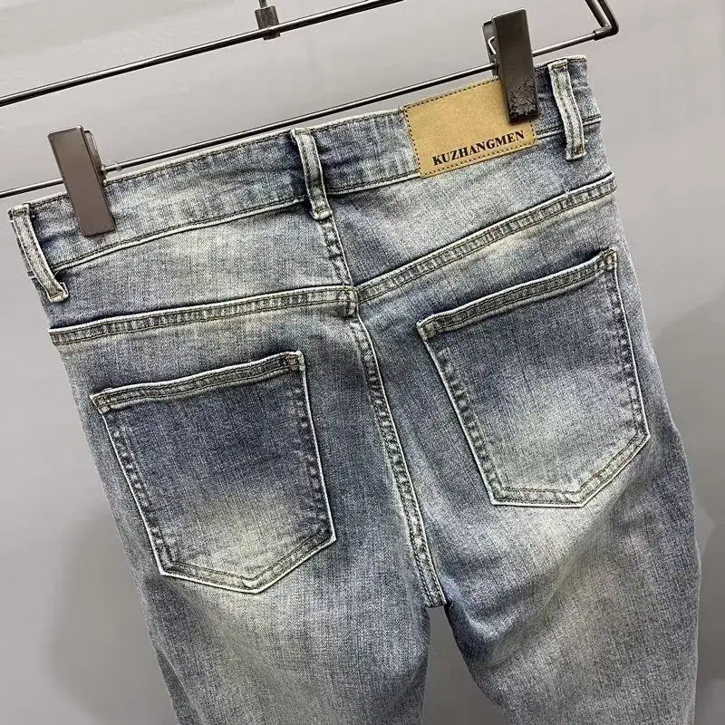 新 2025 高品質ヴィンテージブルースキニージッパーパッチワークオートバイパンツ男スリムフィットジーンズ男プリーツ男デザイナージーンズ