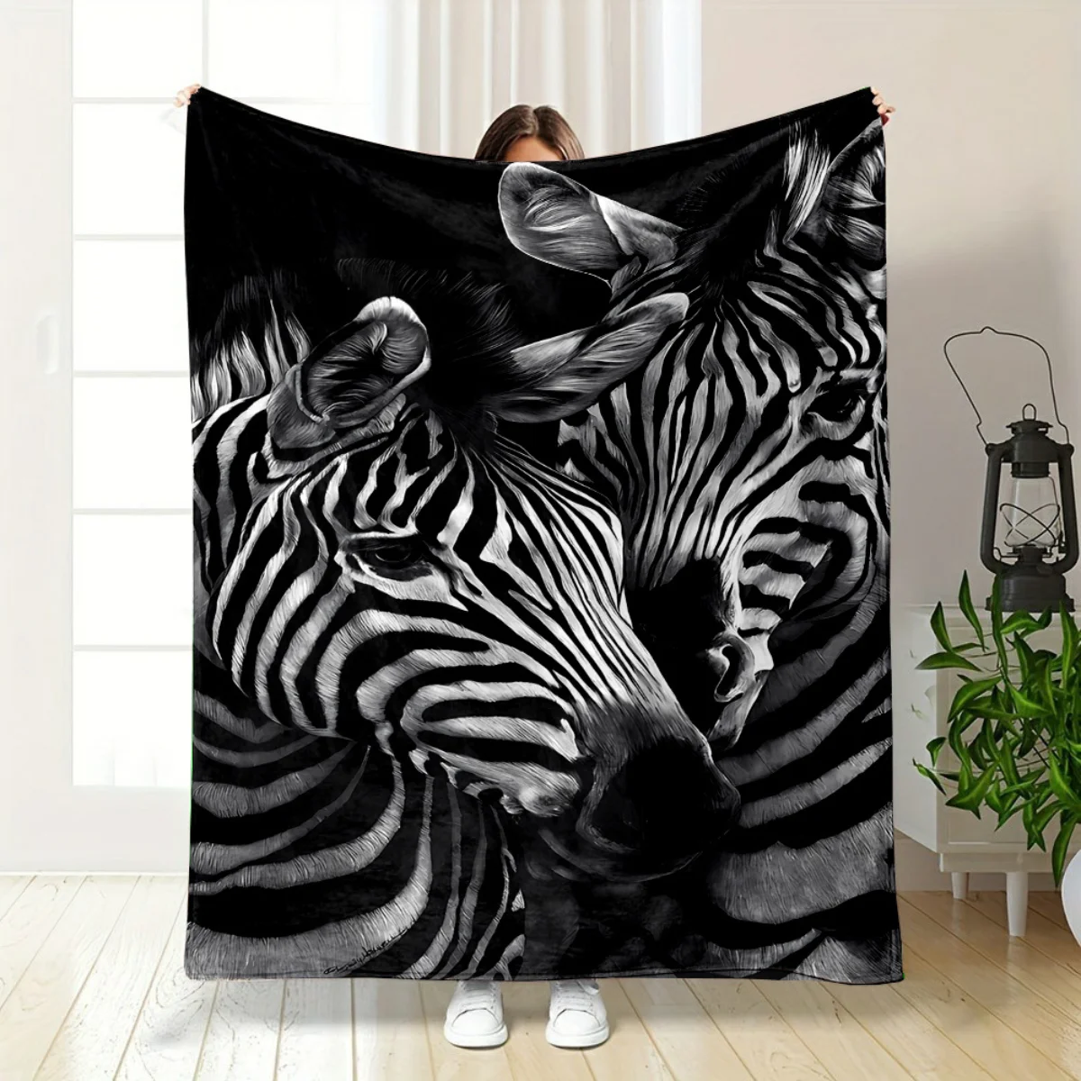 

This zebra-patterned flannel blanket features two animals snuggling together, perfect for sofas, beds, offices, travel, camping,