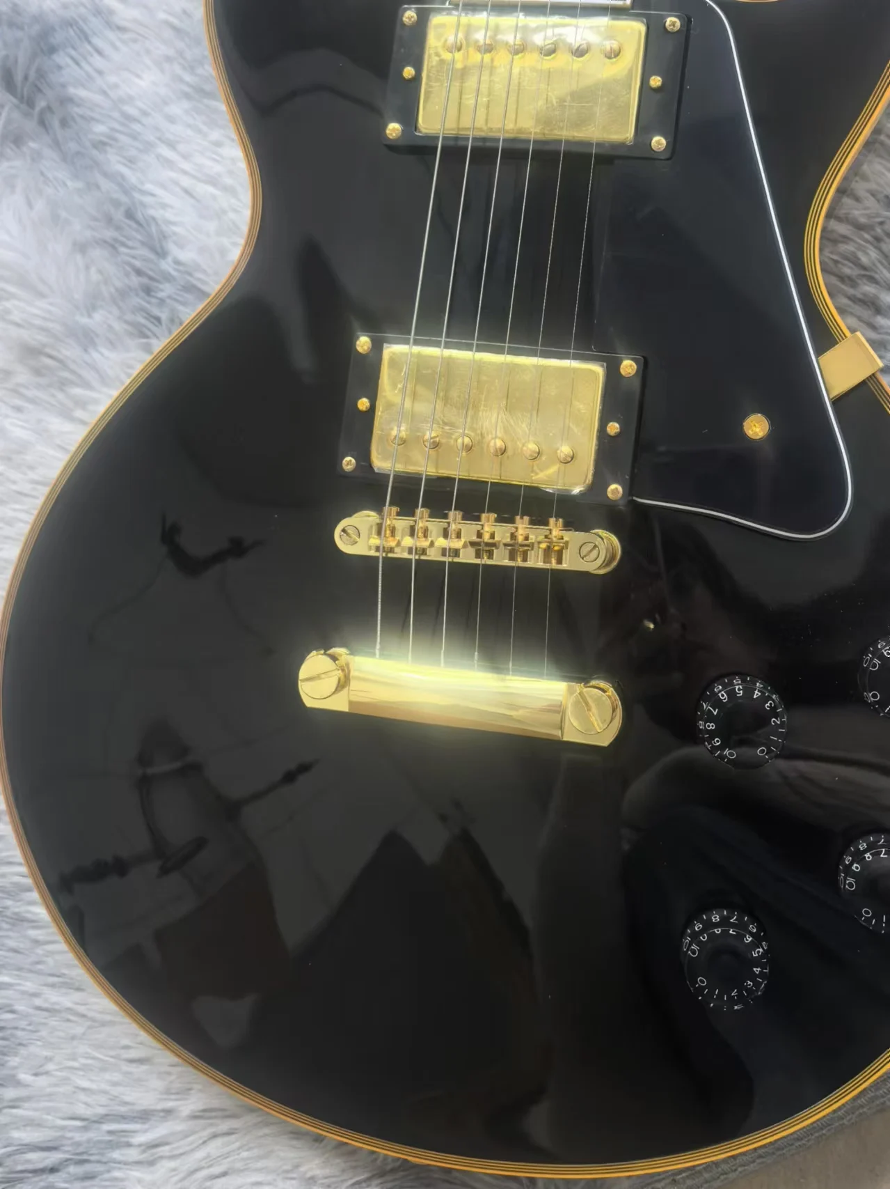 High quality black Lpa electric guitar with gold trim, available in stock