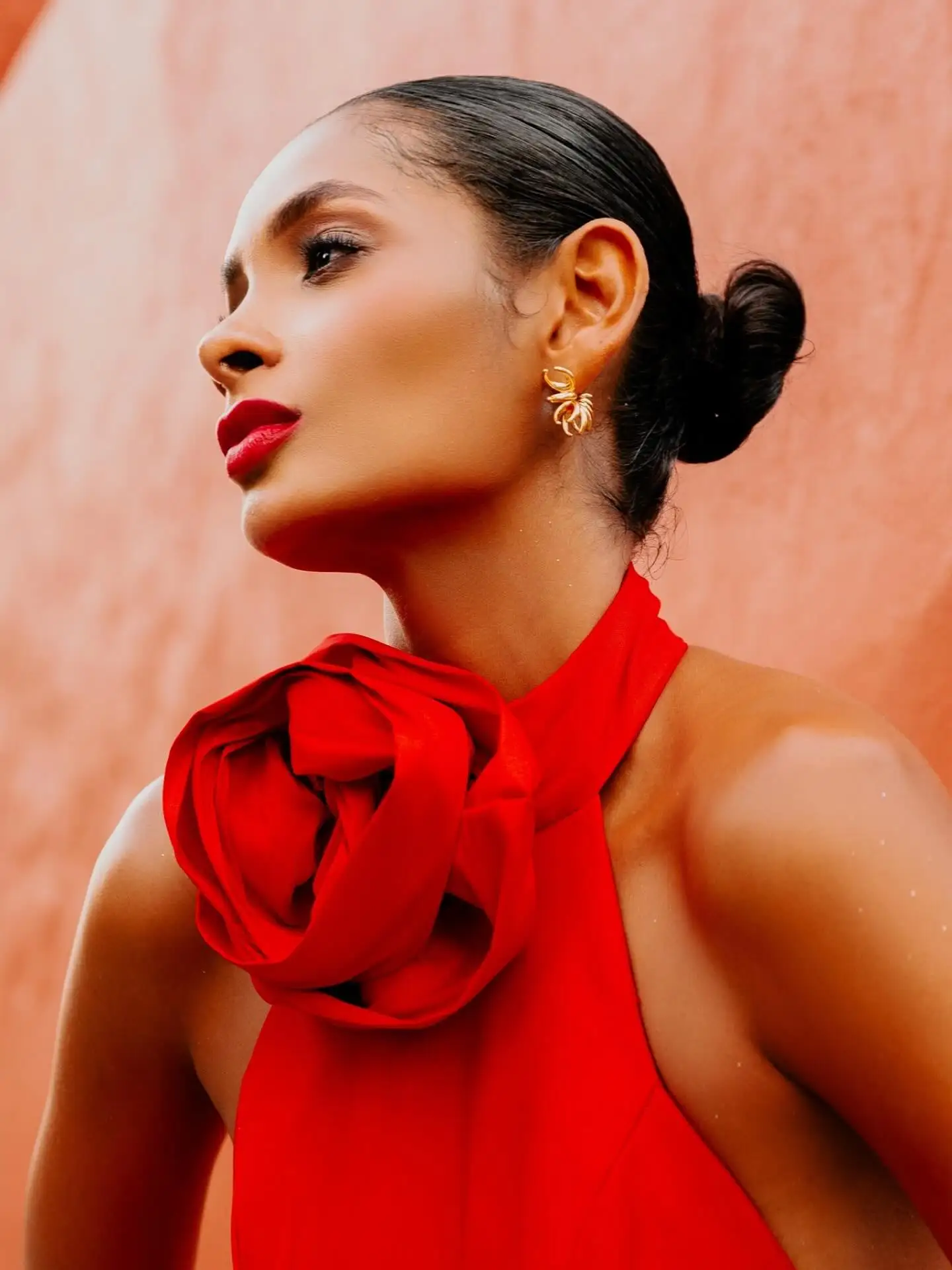 Czerwona suknia balowa typu halter z falbaną przy dekolcie i wysokim rozcięciem z tyłu, jaskrawo czerwona satynowa suknia wieczorowa z rzeźbistym dekoltem z falbanami, oversize.