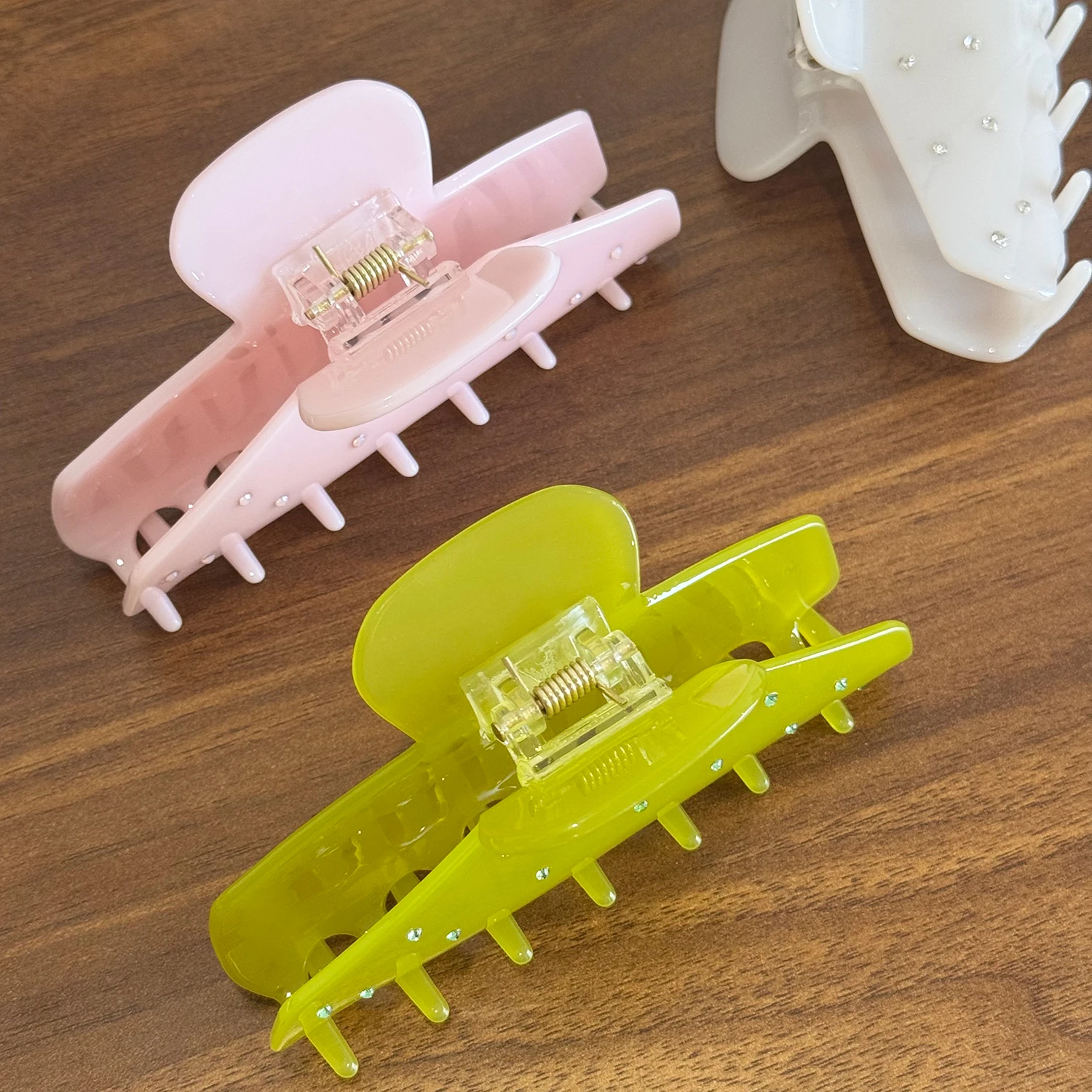 Um versátil grande grampo de cabelo de acetato com agarrador incrustado de diamantes e clipe de tubarão