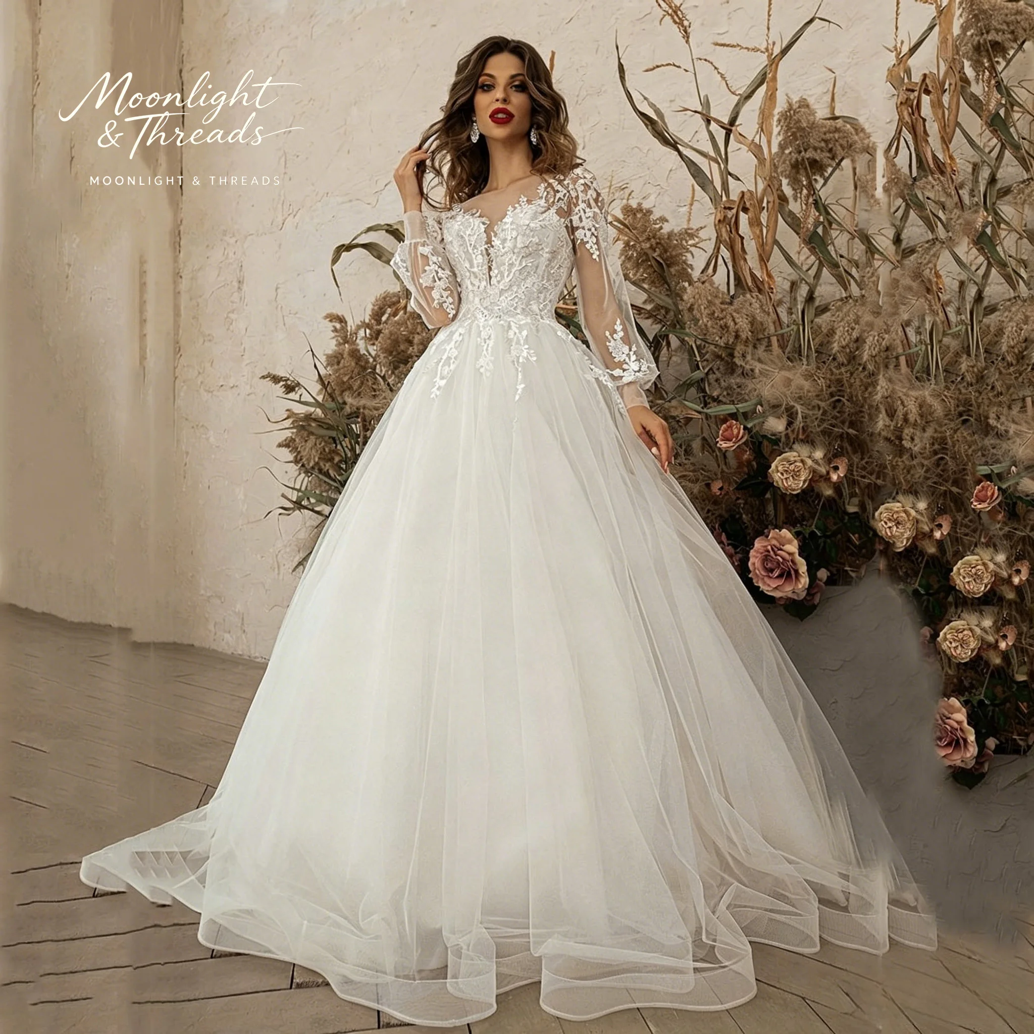 

Floor-length white lace formal wedding gown featuring a round neck long sleeves a full skirt and exquisite embroidery