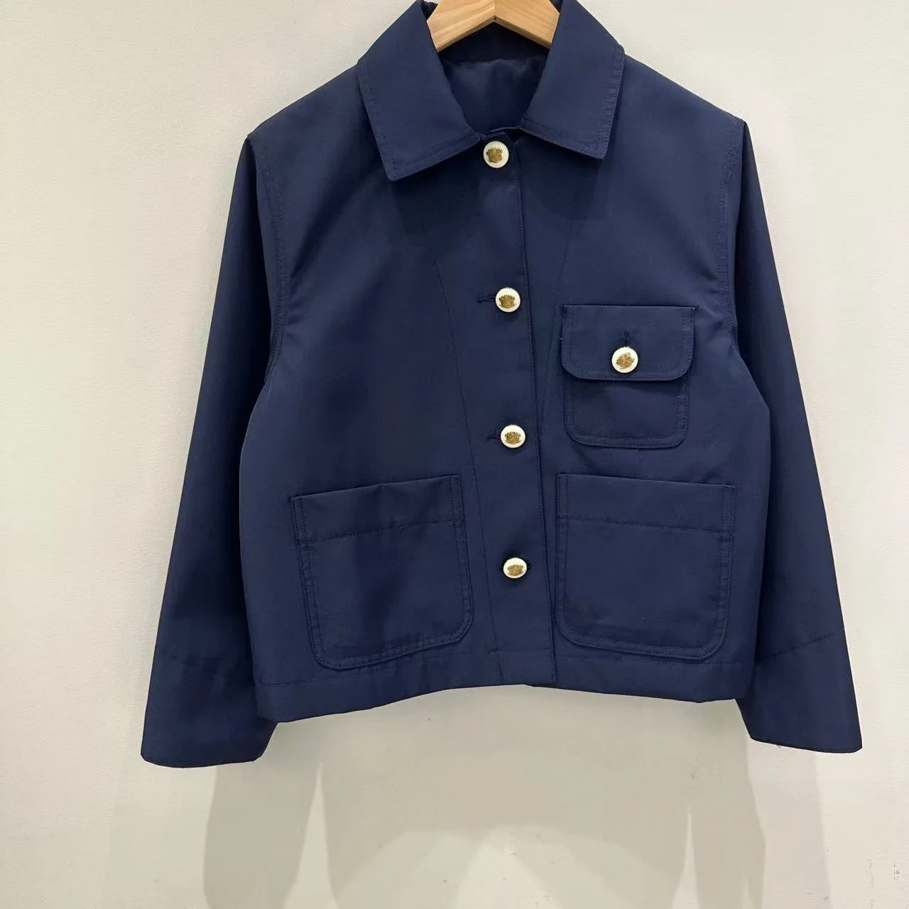 بدلة نسائية أنيقة مكونة من قطعتين باللون الأزرق الداكن على طراز الكلية مع طية صدر السترة وأكمام طويلة أو تنورة رفيعة مكشكشة