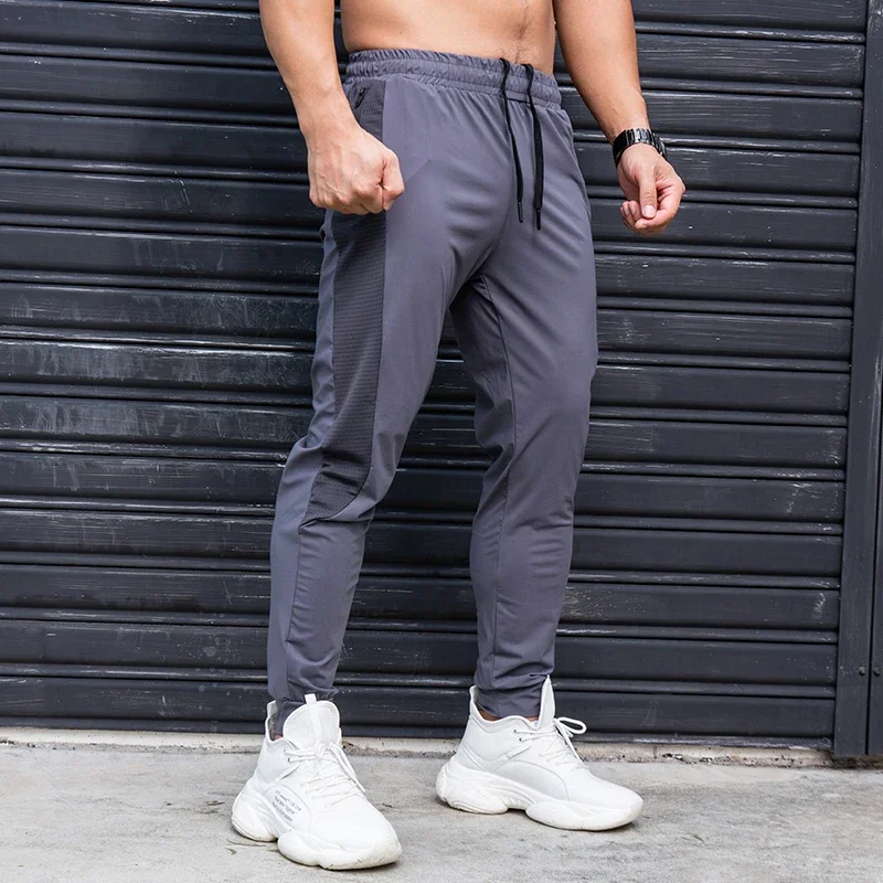 Celana olahraga pria, elastis, kasual dengan saku ritsleting, celana latihan Jogging, kebugaran, Gym