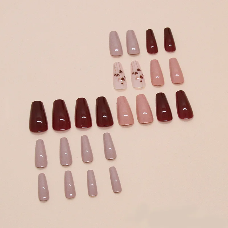 A full set of 24 long coffin-shaped fake nails with solid color fake nails and a heart design, including 1 jelly glue and 1 rub
