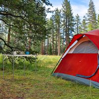 Compact folding camping table, aluminum frame, MDF top, lightweight. Dimensions: 70 x 80 x 60 cm. Silver/grey color. Ideal for o