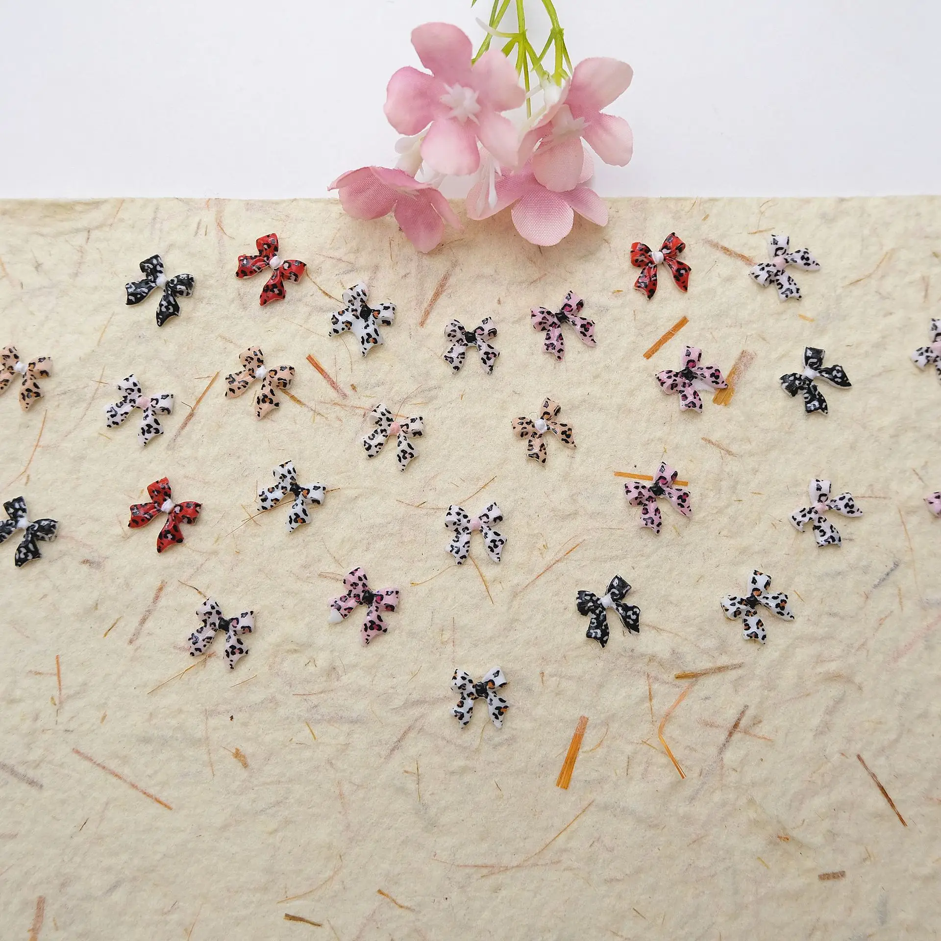 100Pcs Leopard Print Bow Tie Nail Charms - Flowing Ribbon Resin Nail Art, Fashionable Press-On Nail Decor for Stylish Manicures